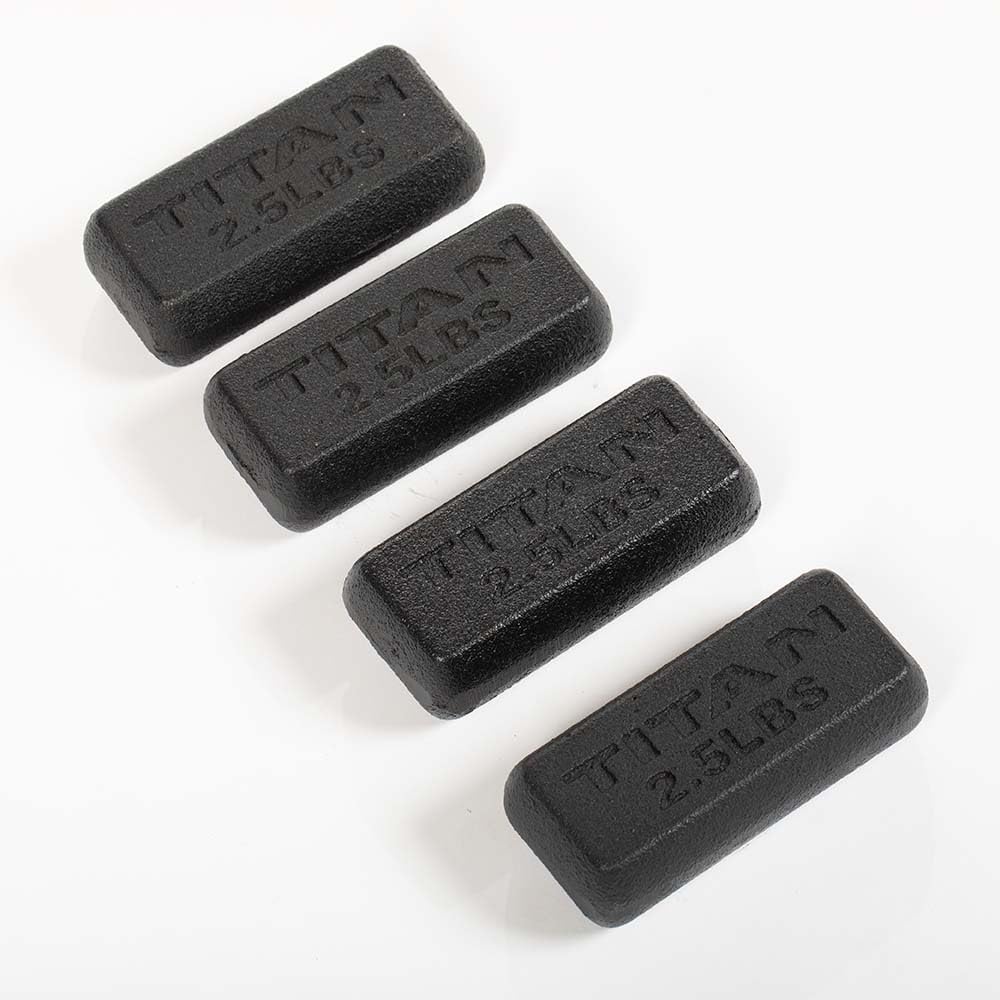 Four black Titan weight blocks, each marked 2.5 pounds, on a white background