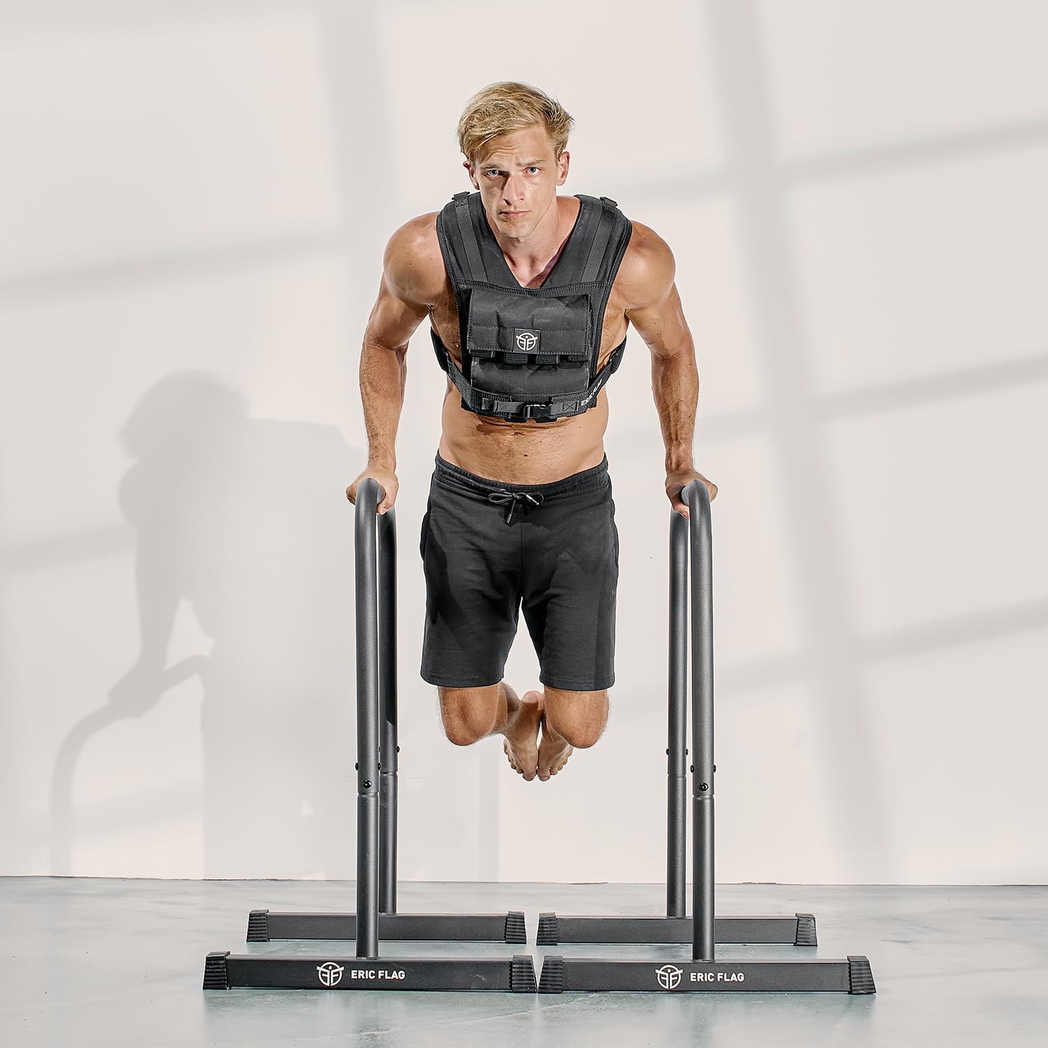 Eric Flag weighted vest worn during a parallel-bar exercise